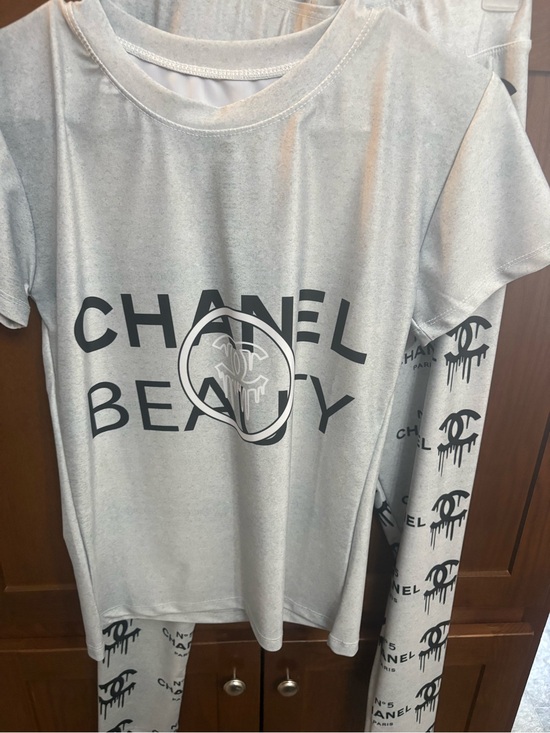 CHANEL Pants - CHANEL Light Gray Beauty Logo Tee with Black Drip CC Accents